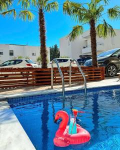 a pool with a pink flamingo in a swimming pool at Hotel HOTI II RIZO ULCINJ in Velika Plaža