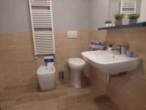 a bathroom with a sink and a toilet and a sink at Casa Chiara by Holiday World in Limone Piemonte +12 photos