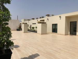 an empty courtyard of a building with a wooden floor at BNR - The Opus Residences - Studio Luxury Apartment Gulberg in Lahore