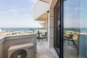 a balcony with a view of the ocean at Miramar - Alezzi Infinity Beach Resort in Năvodari