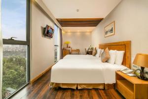 Voodi või voodid majutusasutuse Parkside Sunline Hotel toas