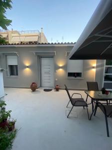 a patio with chairs and a table and a building at Alexandra apartment in Athens