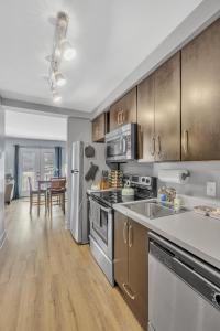 a kitchen with stainless steel appliances and wooden cabinets at The Lofts of Downtown (540 N 2nd St, #208) in Clarksville
