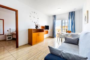 a living room with a couch and a table at Palm Mar Romantic Suite A21 in Palm-mar