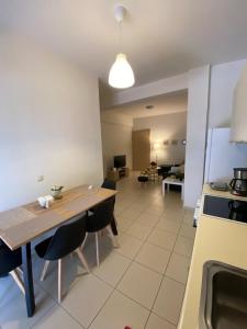 a kitchen with a wooden table and chairs in a room at Athina’s apartment in Athens +13 photos