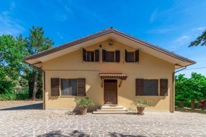 ein Haus mit zwei Fenstern und einer Tür in der Unterkunft Italian Experience - Sunrise Hill Holiday Home in Urbisaglia