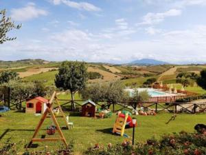 a park with a playground and a pool in the grass at Italian Experience-La Casa di Campagna in Molino di Carassai