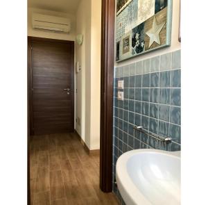 a bathroom with a tub and a wooden door at Italian Experience-La Casa di Campagna in Molino di Carassai +43 photos