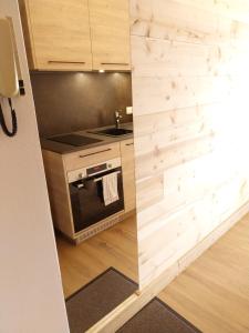 a kitchen with a stove and a counter top at Résidence Plaisance in Gérardmer