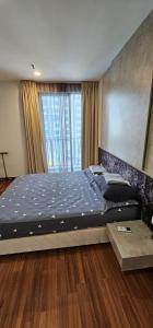 Ένα ή περισσότερα κρεβάτια σε δωμάτιο στο Icity Homestay Isuite