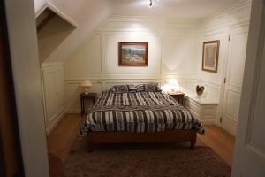 a bedroom with a bed and two end tables at Michel in Trois-Ponts