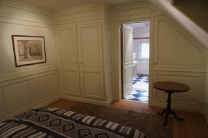 a room with a staircase with a table and a stool at Michel in Trois-Ponts