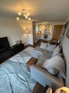a living room with a couch and a table at Golf View in Prestwick