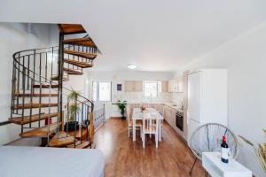 a kitchen and living room with a spiral staircase at Liston Suites in Corfu Town +17 photos