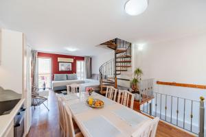 a kitchen and living room with a table and chairs at Liston Suites in Corfu