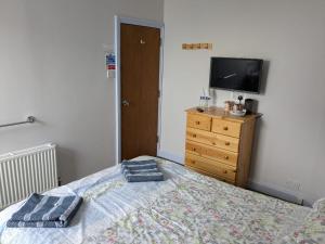 a bedroom with a bed and a tv on a dresser at Burlington in Margate +29 photos