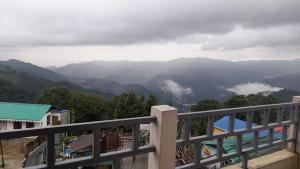 a view of the mountains from the balcony of a house at Dhamcho homestay in Kurseong