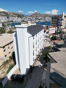 a view of a white building in a city at Niklas Boutique Hotel in Sarandë