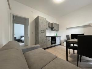 a living room with a couch and a table at Il Villino Lido Spina in Lido di Spina +4 photos