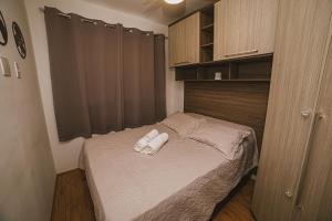 a small bedroom with a bed with towels on it at Chácara Santo Antonio ao lado da Estação João Dias in Sao Paulo +170 photos