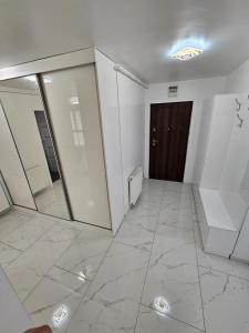 a room with a hallway with mirrors and a door at Filip residence in Cluj-Napoca