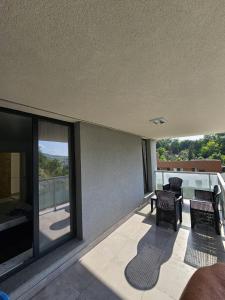 a patio with two chairs and a balcony with a view at Filip residence in Cluj-Napoca