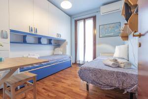 a bedroom with a bed and a desk and a table at Italian Experience- Casale Al Mare in Loreto