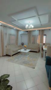 a living room with couches and a table at Royal Dutchess Luxurious Stay Bamburi in Bamburi +4 photos