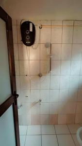 a bathroom with a shower with a phone on the wall at Royal Dutchess Luxurious Stay Bamburi in Bamburi