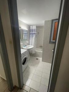 a bathroom with a sink and a toilet and a shower at Maistrato Apartments in Argostoli