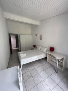 a room with a bed and a table and a laptop at Maistrato Apartments in Argostoli