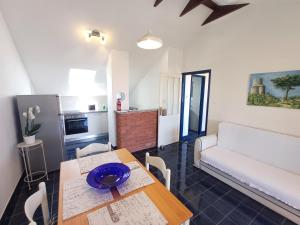 a living room with a table and a couch at Apartmani Saška 2 in Privlaka