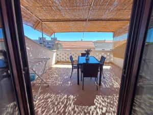 a table and chairs on a balcony with a view at Apartmani Saška 2 in Privlaka