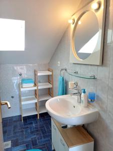 a bathroom with a sink and a mirror at Apartmani Saška 2 in Privlaka +36 photos