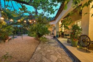 a garden with plants and lights on a building at La ferme Saint-Antoine in Gassin