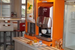 a coffee machine on a counter in a kitchen at Premiere Classe Saumur in Saumur