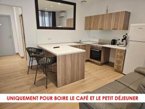 a kitchen with a counter and chairs in a room at L'Escale in Bonifacio