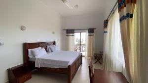 a bedroom with a bed and a window at Alfa Boutique Hotel in Kiwengwa