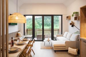 a living room with a couch and a table at Mlino Alpino in Bled