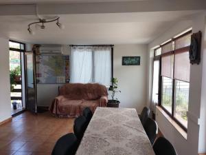a living room with a table and a couch at Casa de Vacanta Simfonia Apelor in Dunavăţu de Jos