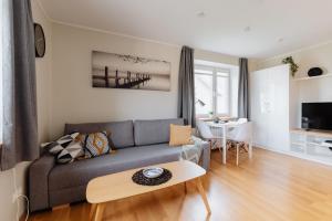 a living room with a couch and a table at Sweet Home apartment in Haapsalu
