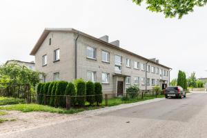 a car is parked in front of a house at Sweet Home apartment in Haapsalu