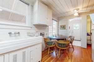 a kitchen with a sink and a table with chairs at Walk to Town! Dog-Friendly Quincy Getaway w/ Deck in Quincy +15 photos