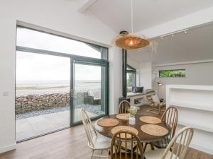 a dining room with a table and chairs at Driftwood Cottage in Ulverston