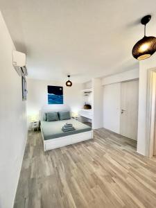 a large living room with a bed and a tv at Kastraki Gem Villa in Kastraki Naxou