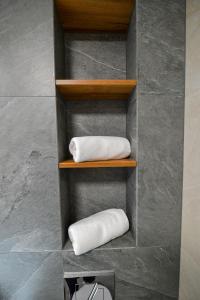 two rolled towels on shelves in a bathroom at Magic Apartments - Aroma Zator in Zator +91 photos