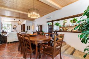 a dining room with a wooden table and chairs at Villa Sado in Alcácer do Sal