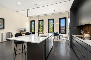 a kitchen with a large white island in a room at NEW! Modern Scandinavian Loft in Old Town Square in Fort Collins