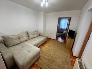 a living room with a couch and a television at Casa Dia in Turda +1 photo