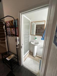 a bathroom with a shower and a sink at Amazing 6 bedroom house with free parking on site. in Norbury